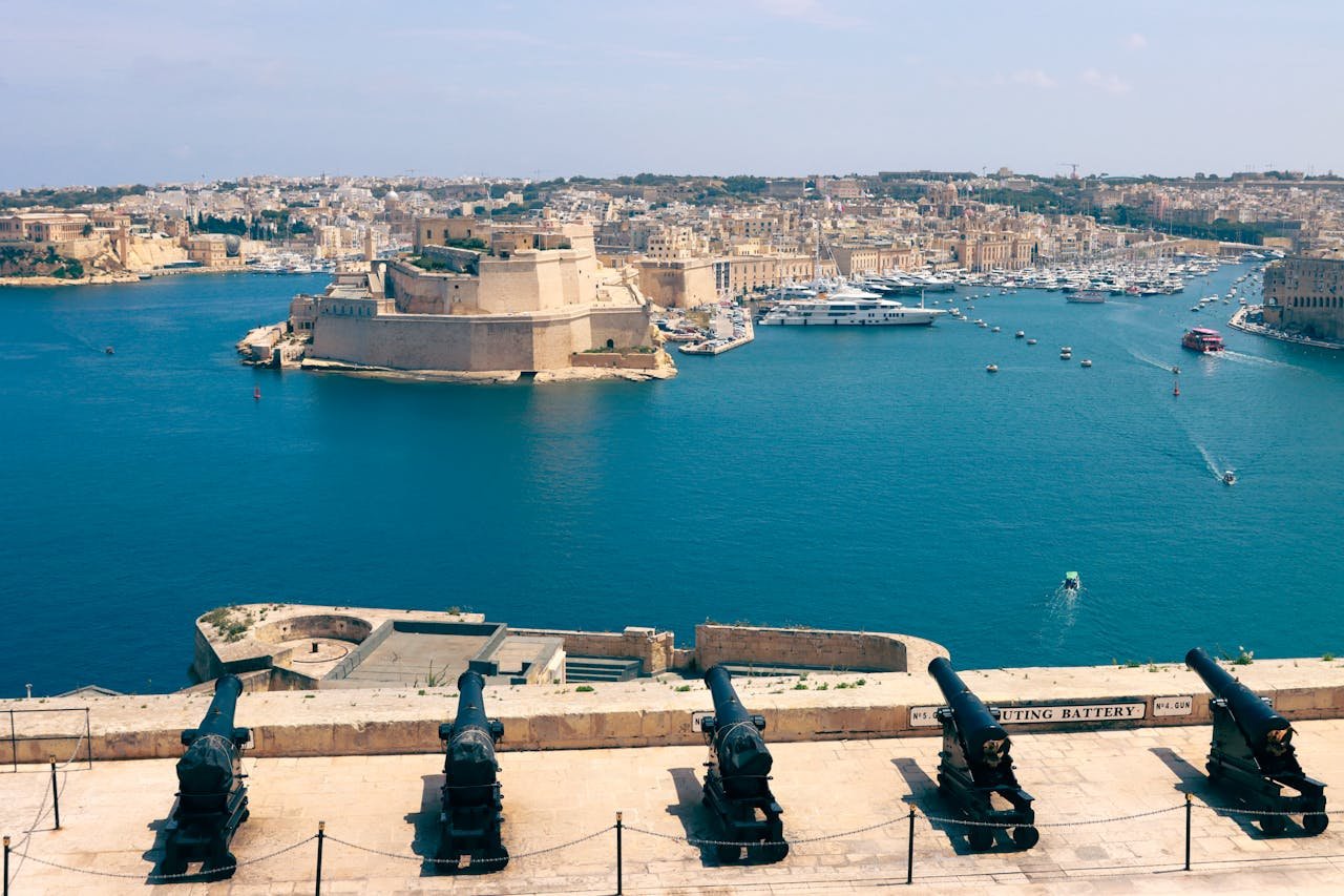 Historic center of Valletta, Malta, with limestone buildings, narrow streets, and Mediterranean charm under clear blue skies.