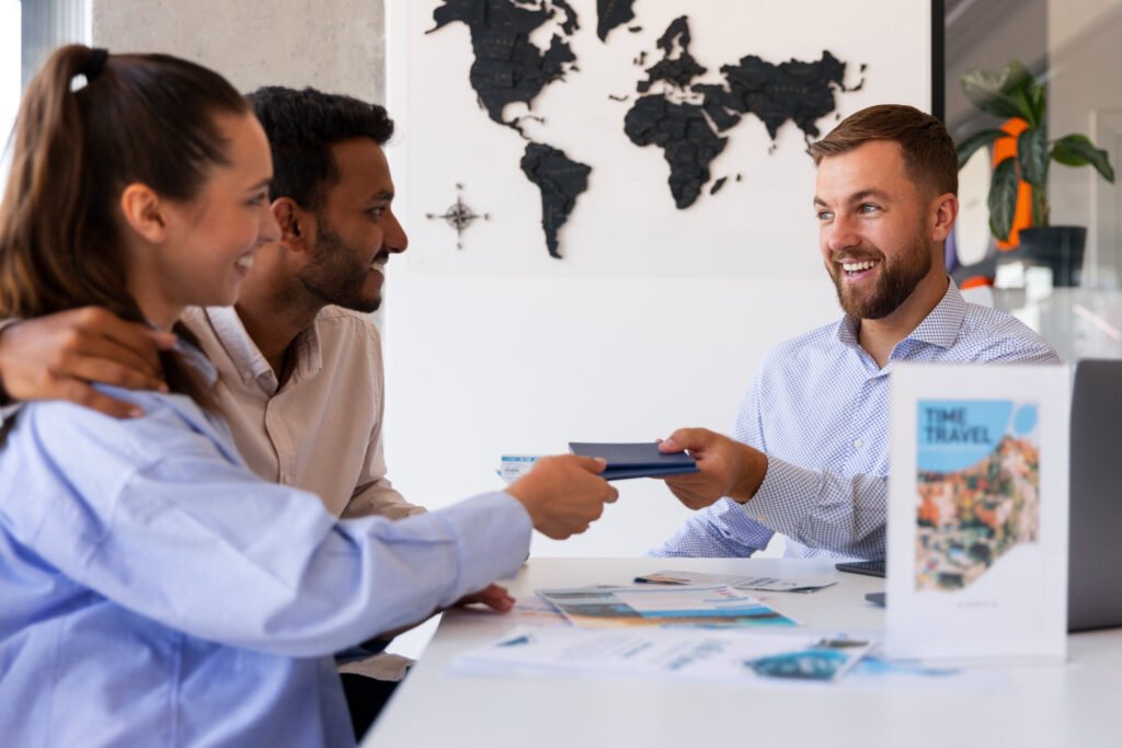 Smiling couple standing next to an agent, apparently just signed their travel insurance; in the background, a white wall with a black world map.







